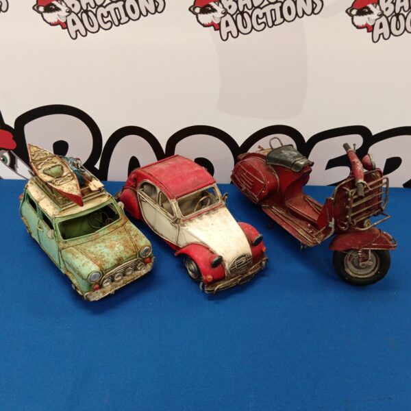 Vintage tin plate toys including Citroen CV, Mini Cooper, and motorcycle.