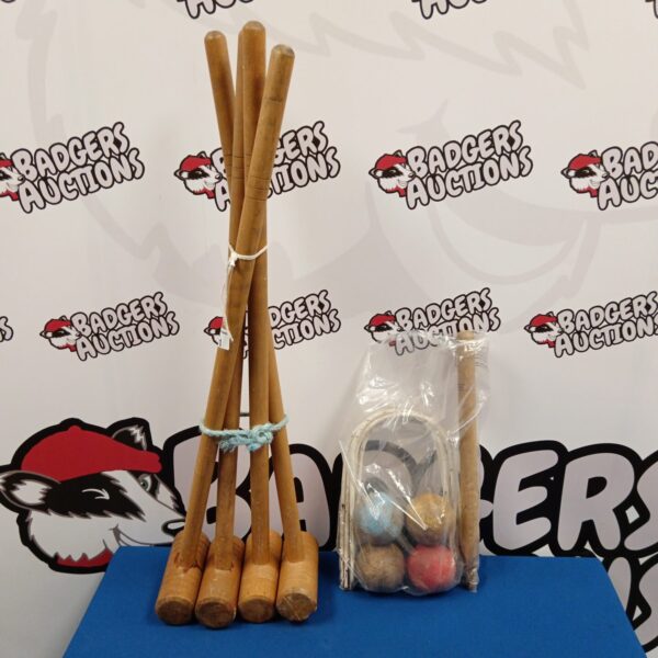 Vintage croquet set with wooden mallets and coloured balls.