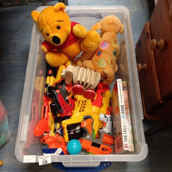 Overview of a mixed toy lot including Winnie the Pooh and Nerf guns.