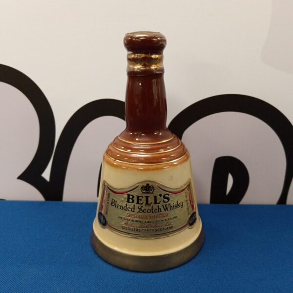 Sealed Bells Scotch Whiskey in ceramic bell bottle, collectible vintage liquor.