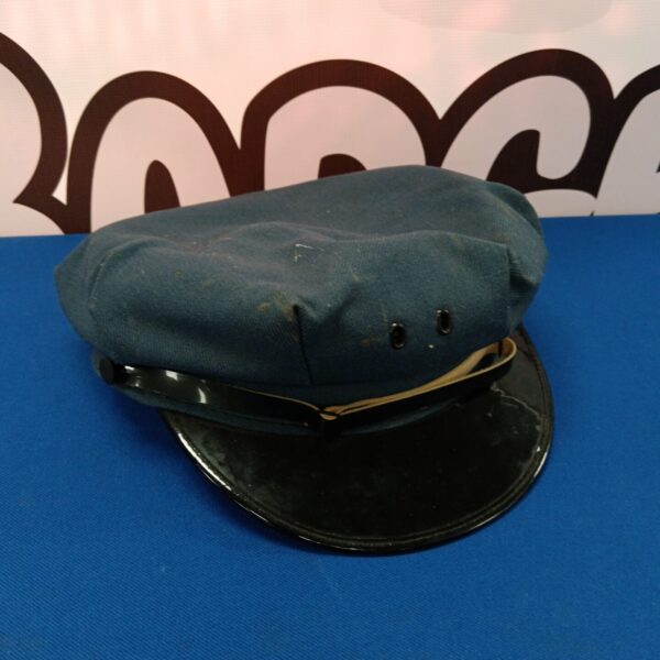 Front view of a vintage blue bus driver hat with peak.