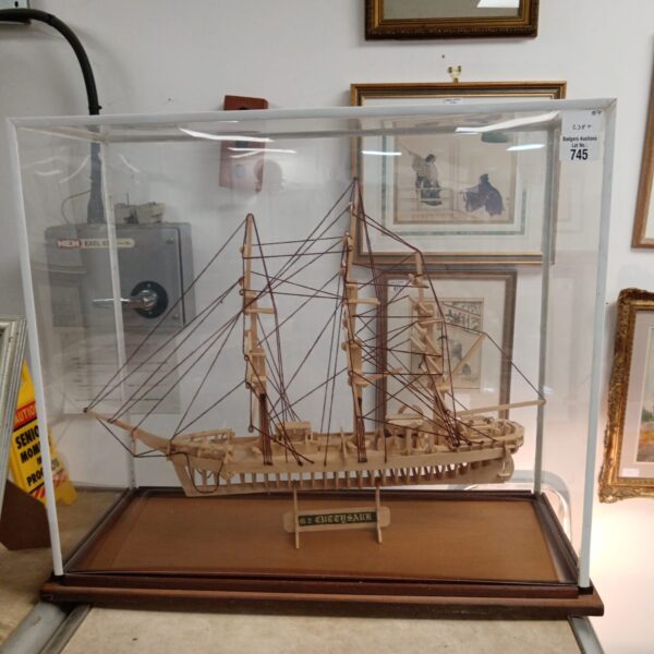 Vintage Cutty Sark model ship in a glass display case.