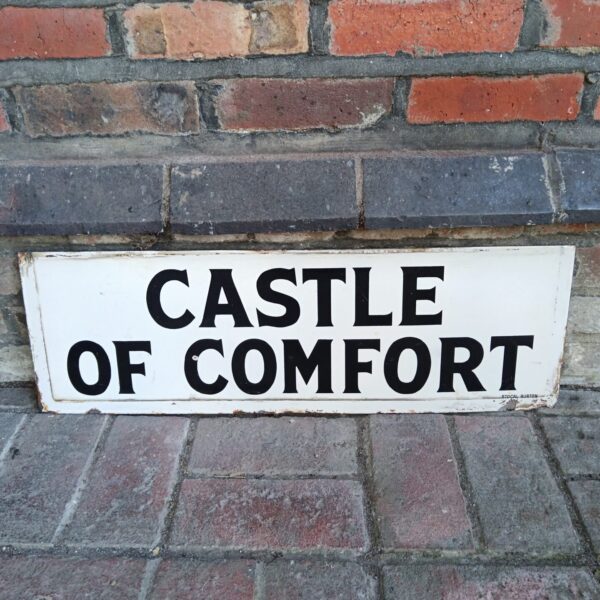 Vintage enamel "Castle of Comfort" sign with classic lettering.