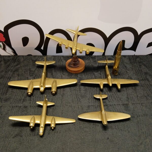 Detailed brass WW2 aircraft collection with bullet.
