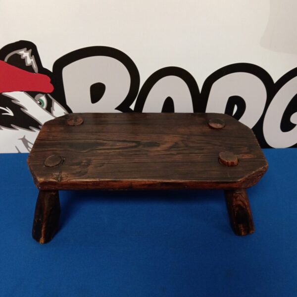 Vintage rustic wooden footstool for farmhouse decor.