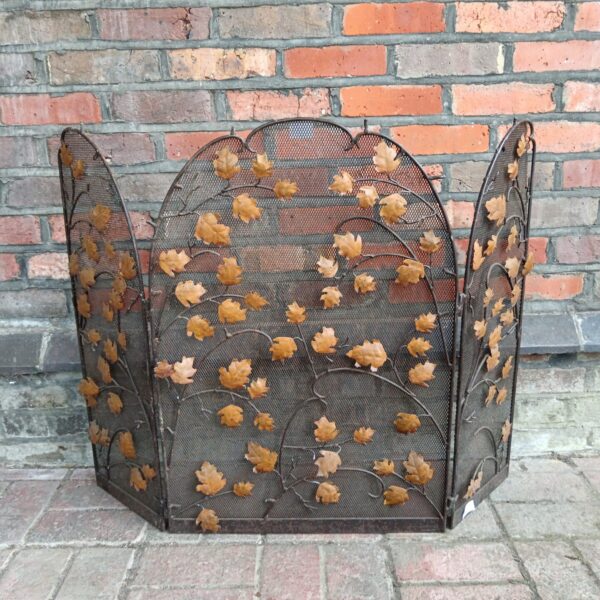 Vintage iron folding firescreen with leaf pattern detail.