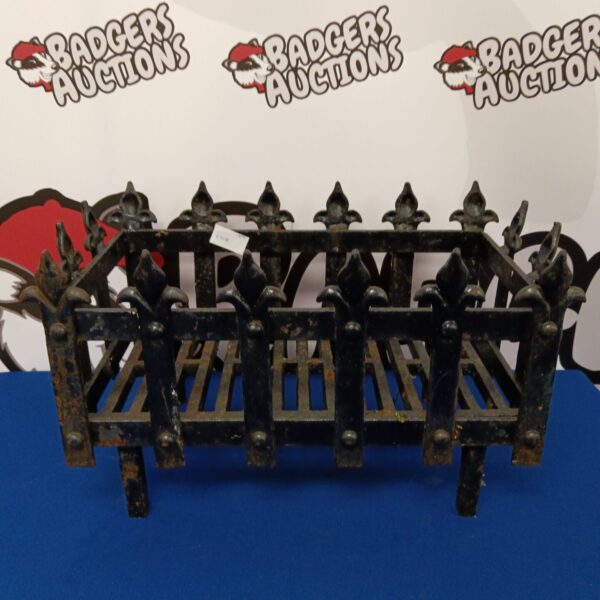Antique wrought iron fire basket with decorative scrolling ironwork.
