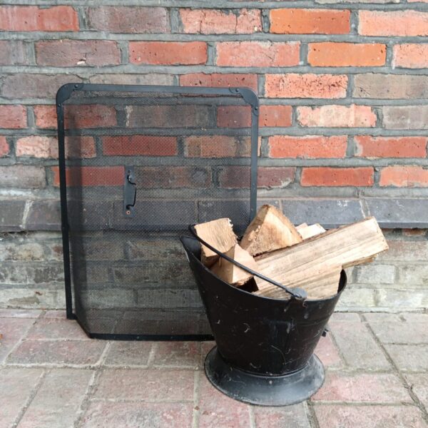 Vintage fireplace log bucket and firescreen set for firewood storage.