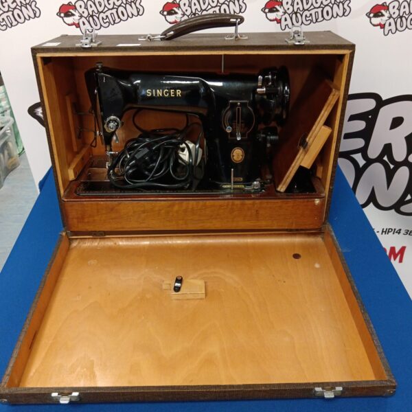Vintage Singer 201k sewing machine in black, side view.