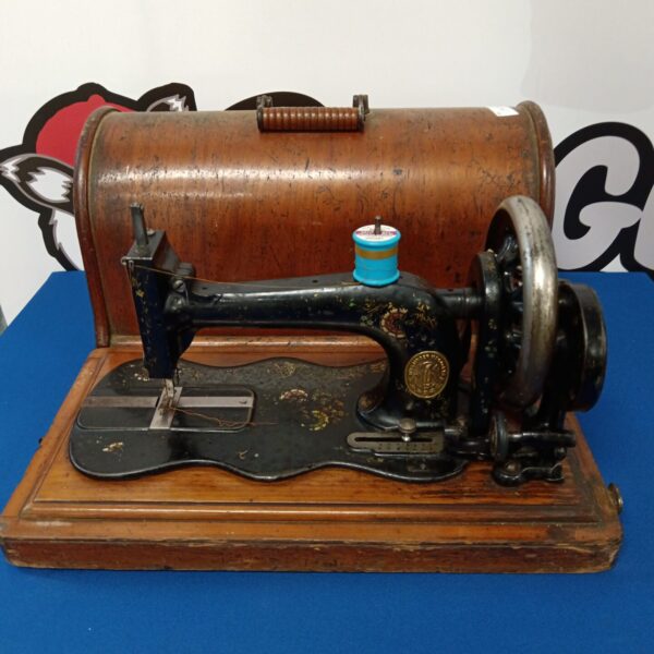 Antique Singer sewing machine with hand crank mechanism.