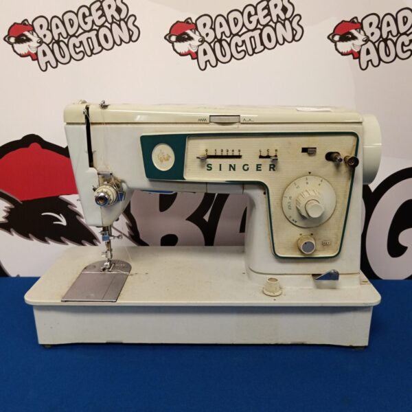 Vintage Singer sewing machine in used condition, classic retro style.