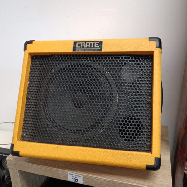 Vintage orange Crate Taxi guitar amplifier with front grill.