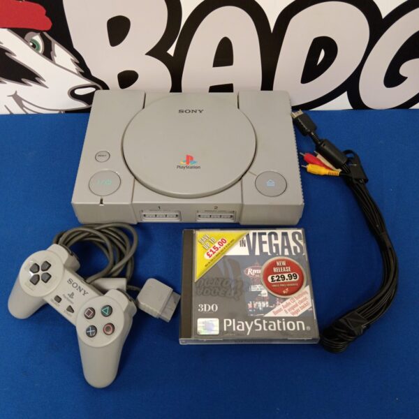 Grey Sony Playstation console with controller and cable.