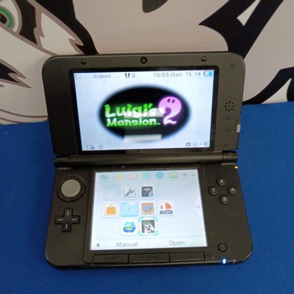 Nintendo 3DS console displaying Luigi's Mansion game on screen.