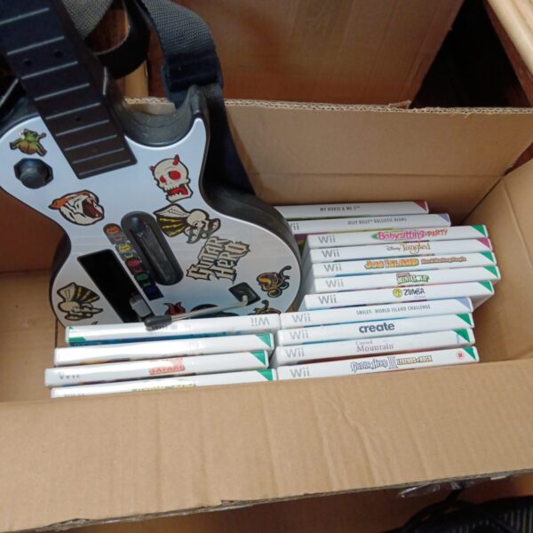 Nintendo Wii bundle with guitar controller and games displayed.