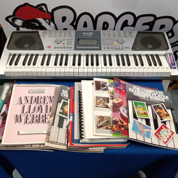 Rock Jam RJ-661 keyboard with sheet music for musical learning.