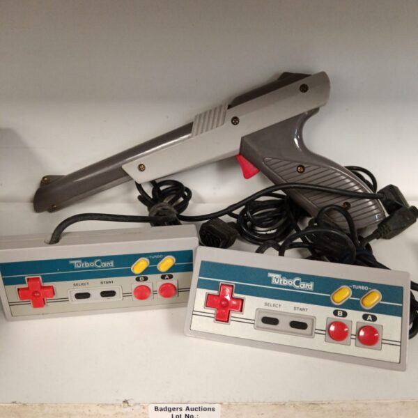 Vintage Nintendo NES light gun and turbo controllers for retro gaming.