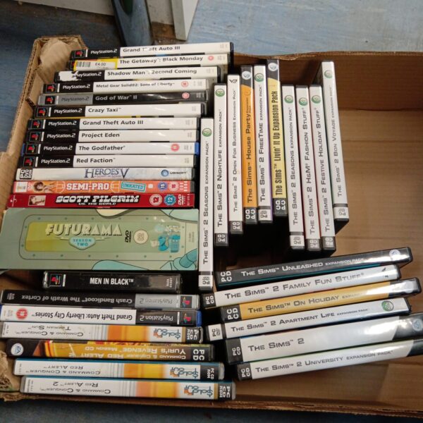 Tray of Playstation 2 games and PC games for retro gaming collectors.