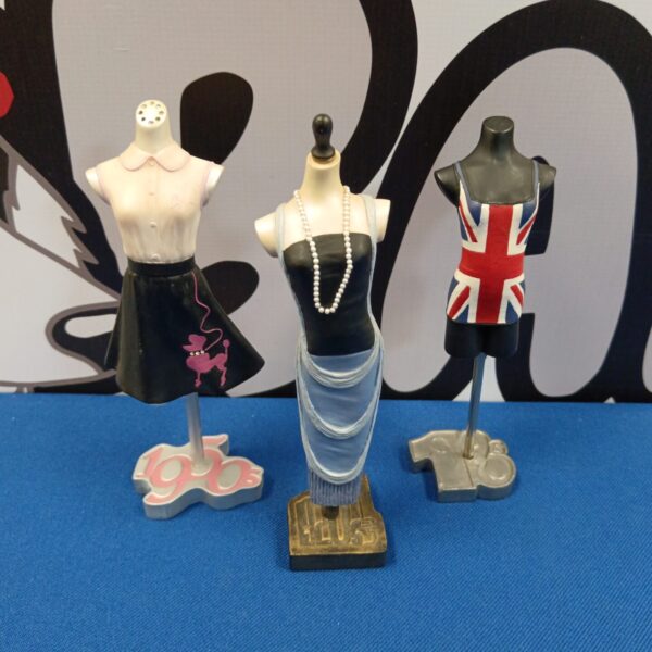 Miniature magazine figure in a black and white polka dot dress.