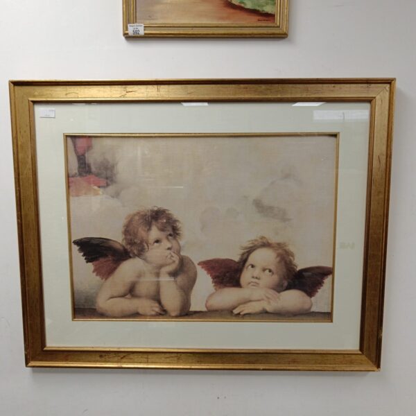 Large gilt framed cherub print for vintage wall decor.