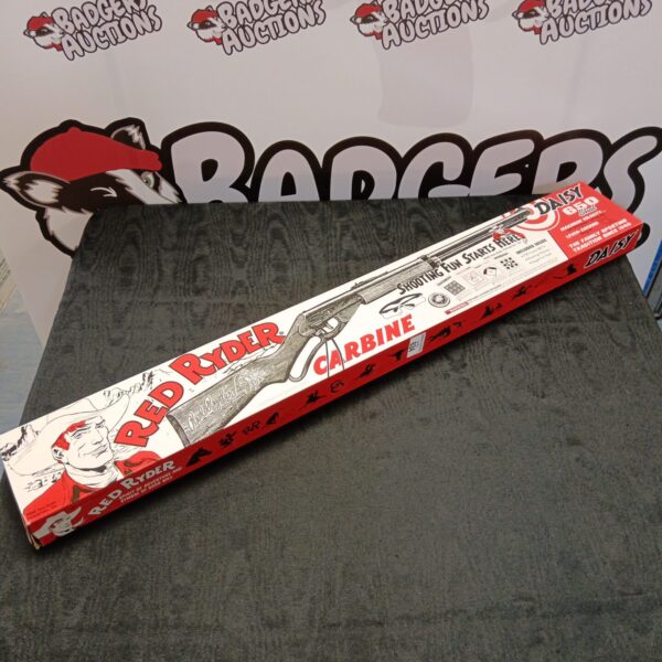 Vintage Red Ryder carbine in original box, a classic toy rifle.