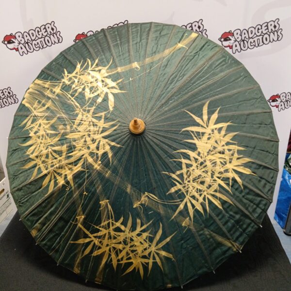Antique Chinese parasol with bamboo frame and floral pattern.
