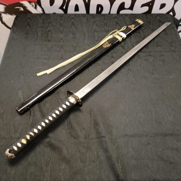 Detailed Japanese katana sword with a striking devil motif.
