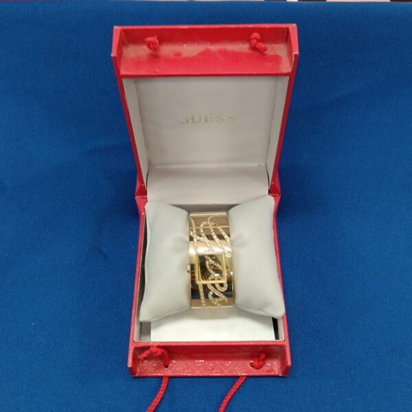Ladies’ Guess gold watch presented in original packaging.