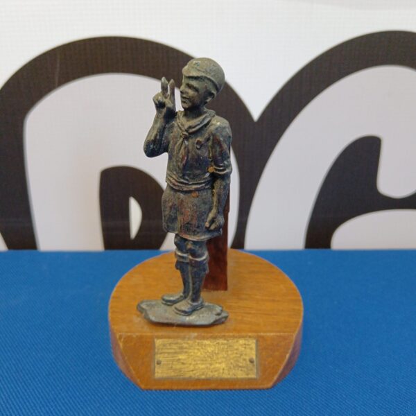 Detailed vintage boy scout trophy figurine on wooden base.