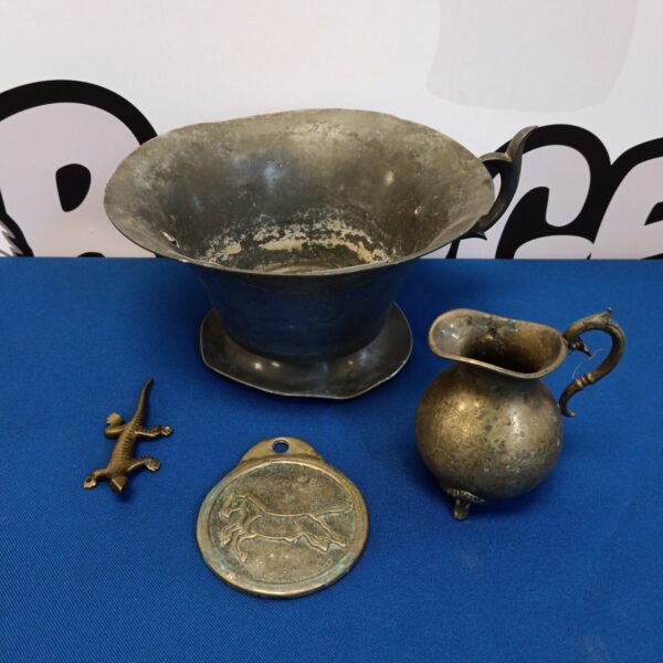 Antique pewter bowl and brass collectibles in a vintage lot.