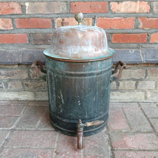 Antique copper fermentation vat with tap, vintage brewing equipment.