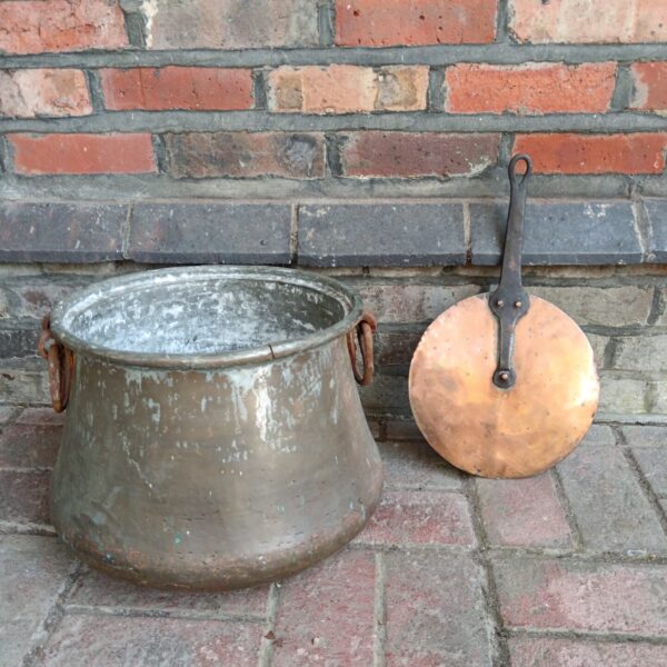 Antique copper pot with wrought iron handle and lid.