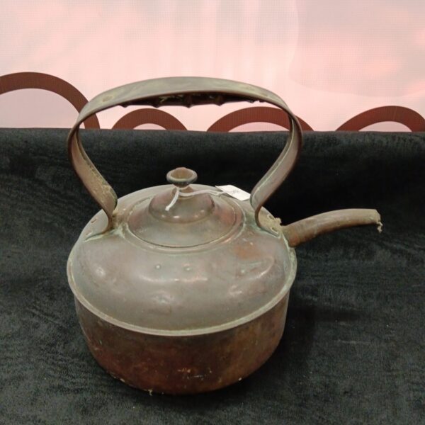 Antique copper kettle with curved handle and spout.
