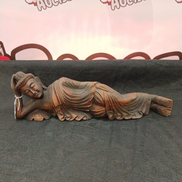 Antique carved wooden recumbent Buddha statue, detailed religious sculpture.