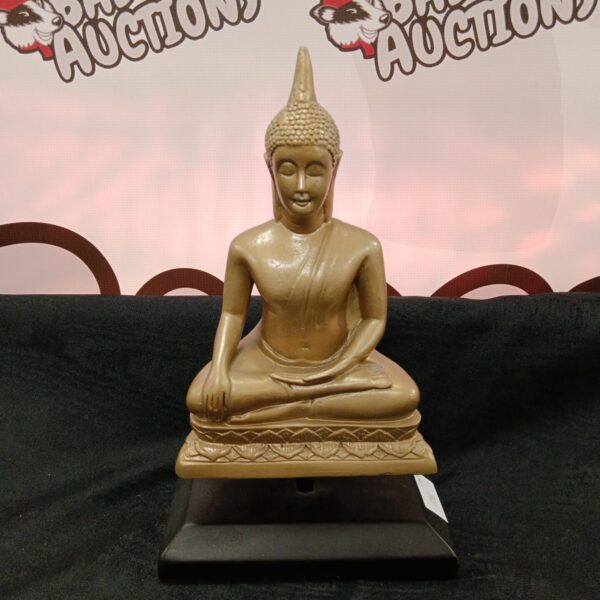 Gold tone Buddha statue on plinth for home decor.