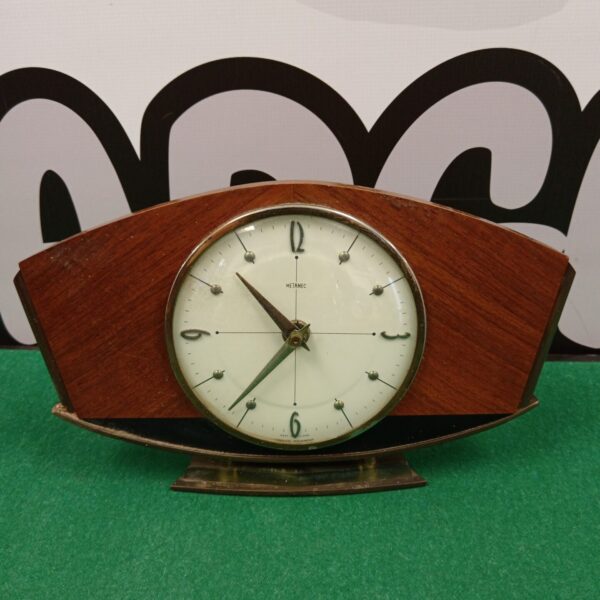 Vintage Metamec mantle clock with wooden case and minimalist face.