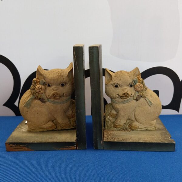 Vintage wooden pig bookends, detailed carving, rustic farmhouse decor.
