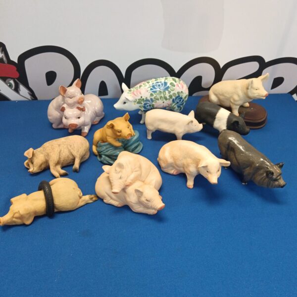 Collection of vintage ceramic pig ornaments, including Royal Doulton.