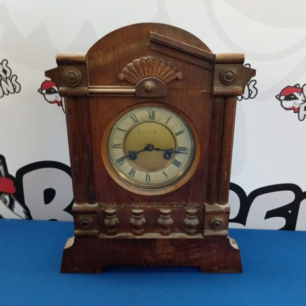 Vintage oak mantle clock with Roman numerals.