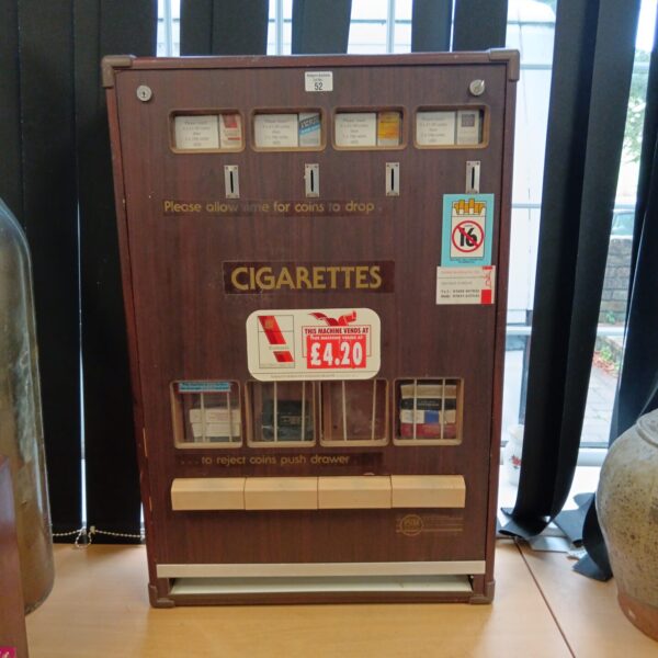 Vintage PVM cigarette machine in wooden cabinet, collectible pub item.