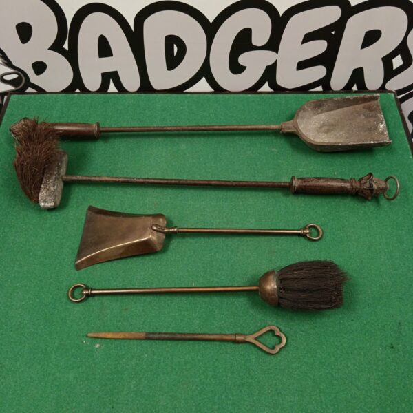 Vintage fireplace companion tools set including poker and shovel.