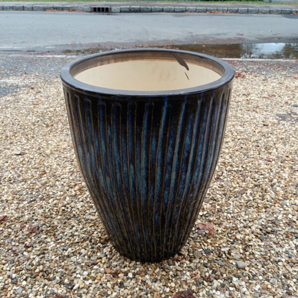 Large blue glazed ceramic plant pot with ribbed texture.