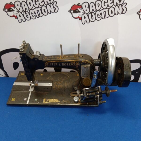 Antique Frister & Rossman hand crank sewing machine, vintage collectible.