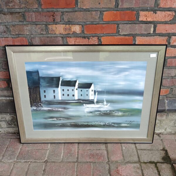 Large framed coastal cottage print with boats and a seascape.