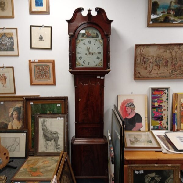 Antique grandfather clock in a room full of art.