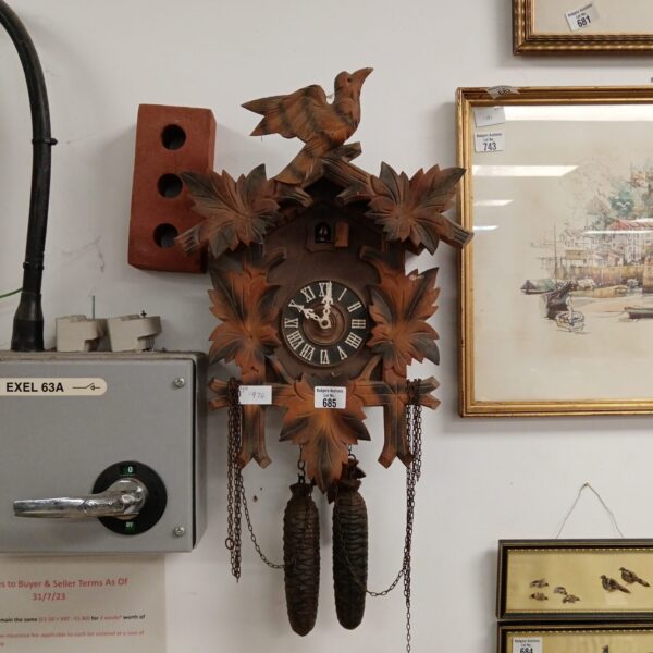 Detailed front view of a vintage Black Forest cuckoo clock.