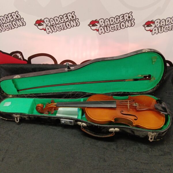 Vintage Lark violin in open case with bow and rosin.