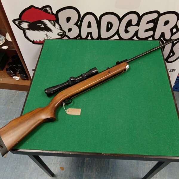 Vintage BSA Airsporter .22 air rifle with scope, side view.
