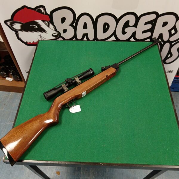 Vintage Webley Vulcan .22 air rifle with scope, side view.