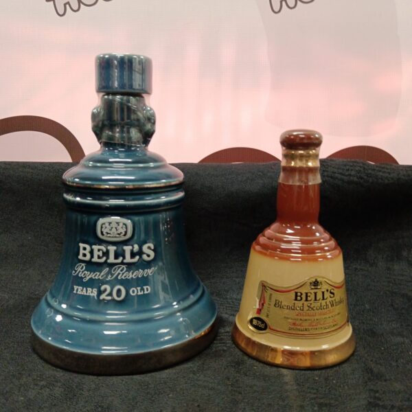 Pair of vintage Bells Scotch Whiskey decanters in blue glaze.